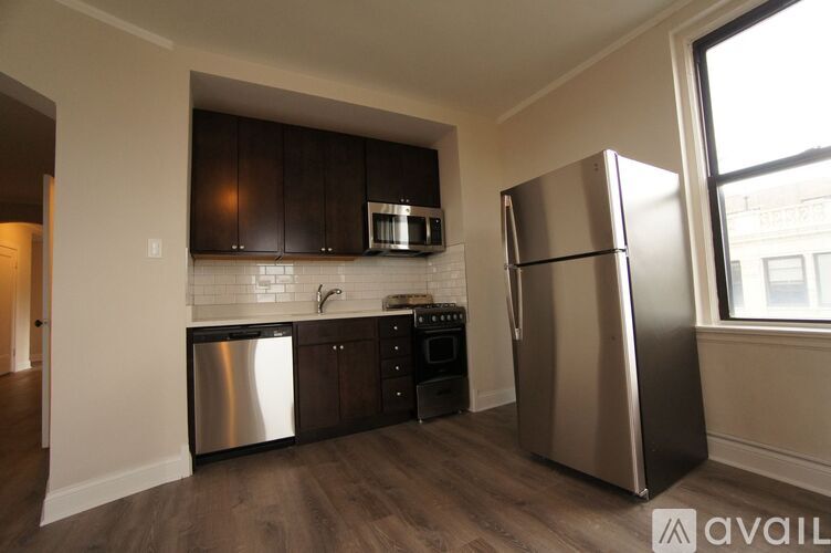 A kitchen with a refrigerator, stove, and dishwasher.