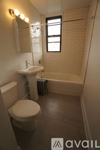 A bathroom with a toilet, sink, and tub.