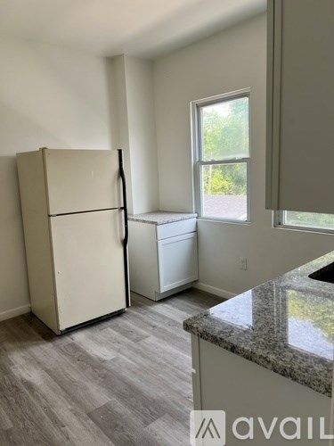 A kitchen with a granite countertop and a window.