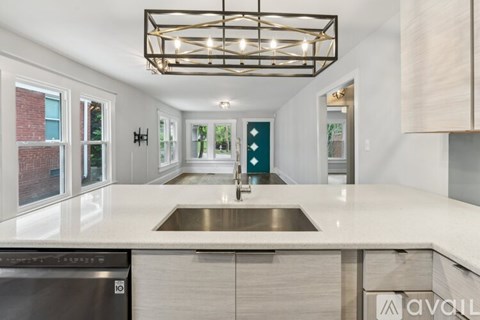A modern kitchen with a stainless steel dishwasher and a sink.