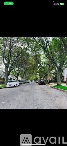 A street view with cars parked on the side of the road.
