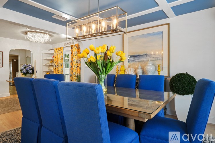 A dining room with blue chairs and a wooden table.