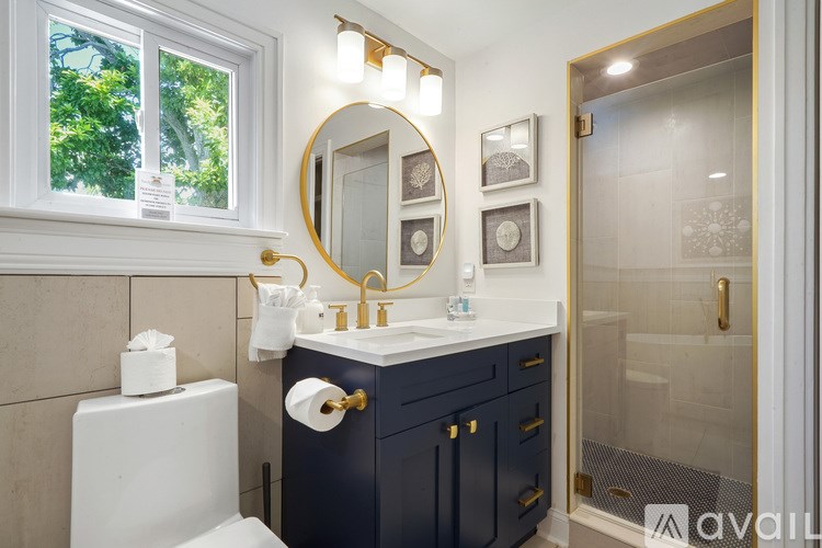 A bathroom with a white toilet, a sink, and a mirror.
