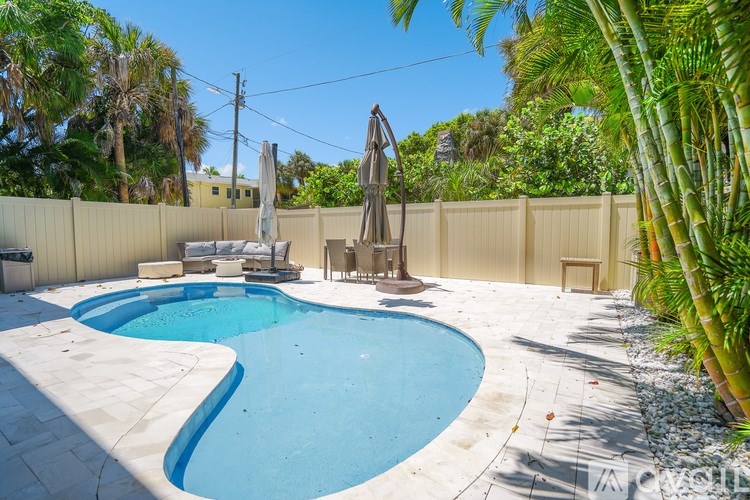 A small pool with a slide in a backyard.