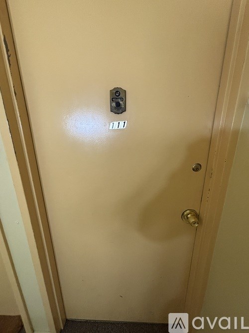 A white door with a handle and a lock.