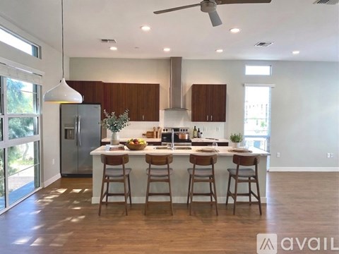A modern kitchen with wooden cabinets and a central island.