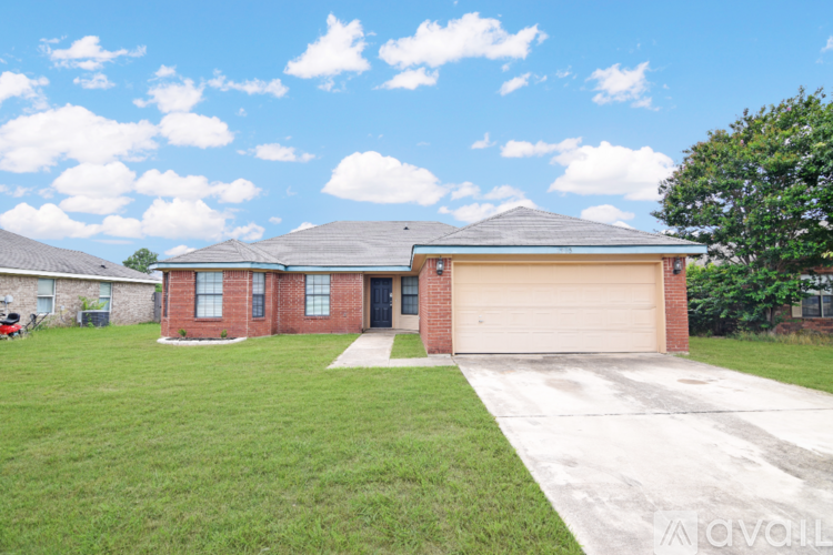 A house with a garage and a driveway in front.