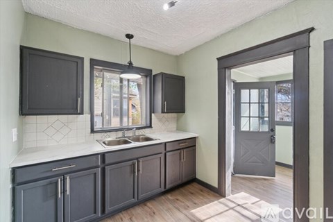 A kitchen with a sink and a window.