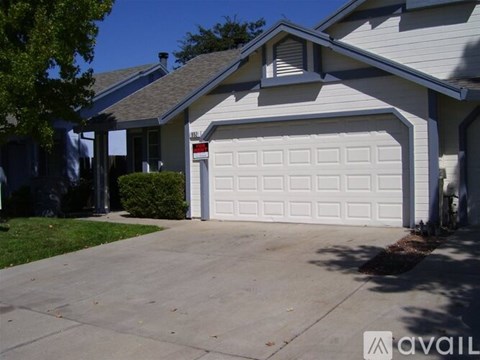 A house with a white garage door and a driveway.