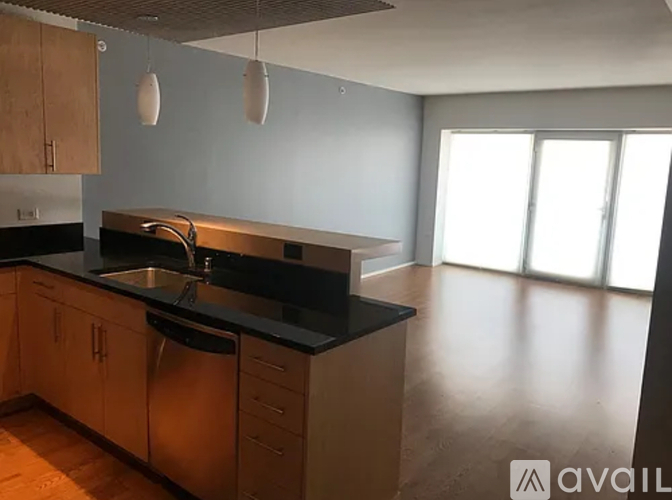 A kitchen with wooden cabinets and a black countertop.