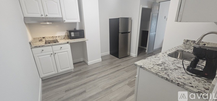 A kitchen with a granite countertop and a sink.