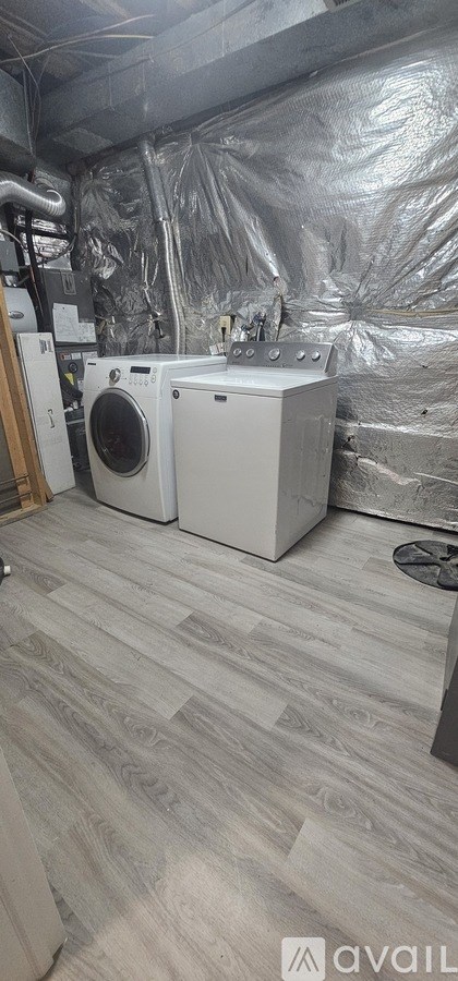 A room with a washing machine and dryer in it.