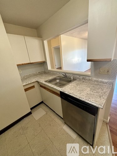 A kitchen with a sink and a dishwasher.