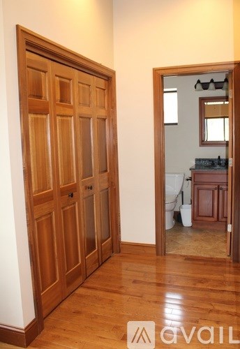 A room with a wooden floor and a wooden door.