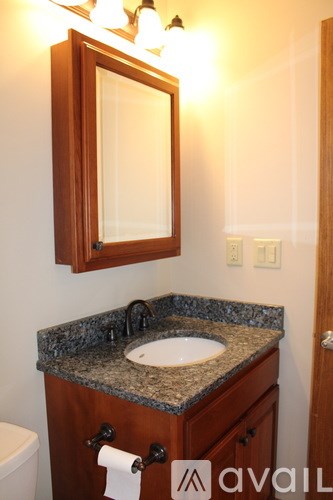 A bathroom with a sink and mirror.