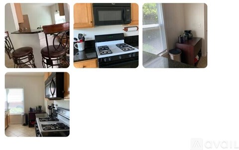A kitchen with a stove, microwave, and a TV.