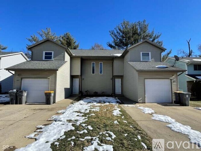 A house with a driveway and garage doors.