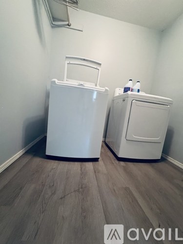 A room with a table, chairs, and a printer.