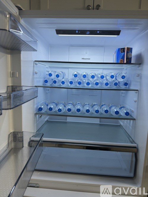 A refrigerator with a glass shelf and a box labeled "Riviera" on top.