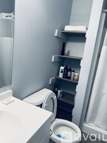 A man is standing in front of a microwave.