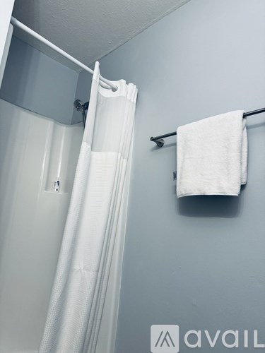 A white towel is hanging on a towel rack.