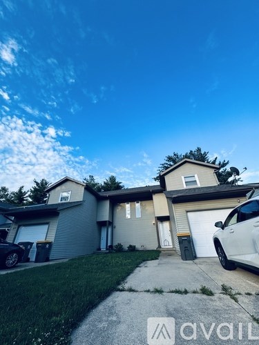 A house with a car parked in front of it.
