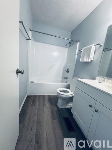 A bathroom with a toilet, sink, and bathtub.