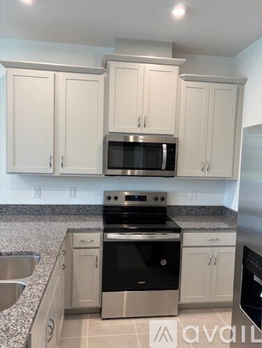 A kitchen with a stove top oven and microwave.