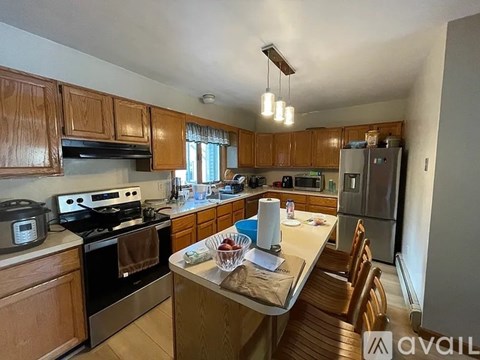 A kitchen with wooden cabinets and stainless steel appliances.