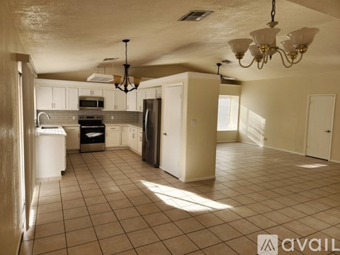 A kitchen with white cabinets and a black stove top oven.