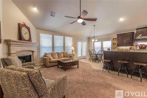 A living room with a leopard print chair and a fireplace.