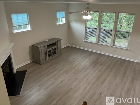 A living room with a fireplace and a tv stand.