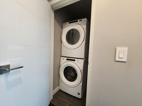 A white washing machine is in a small space.
