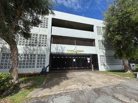 A white building with a black gate and the words "KINAWAY BASE" written on it.