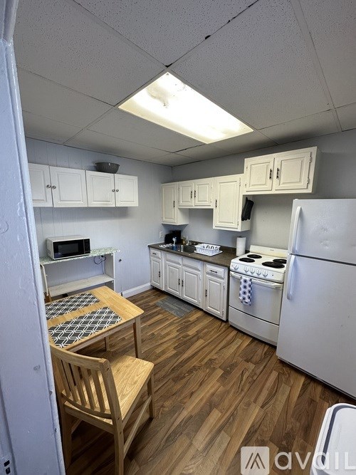 A small kitchen with a table and chairs.