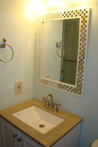A bathroom with a sink and mirror.