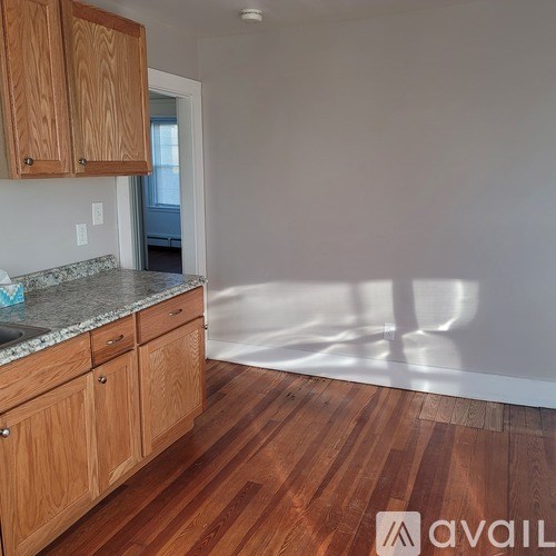 A kitchen with wooden cabinets and a granite countertop.