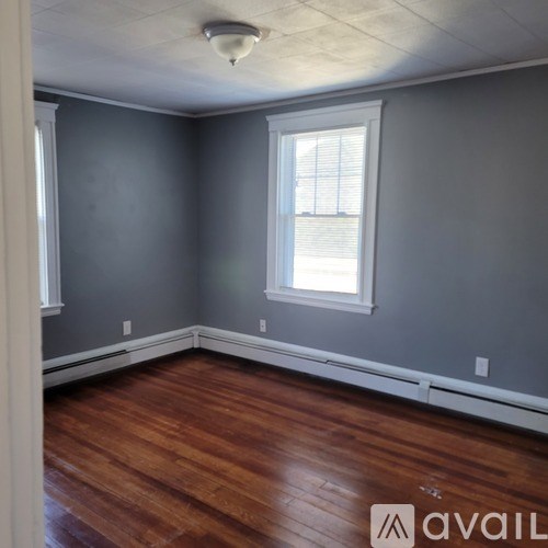 A room with wooden floors and a window.