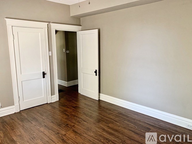 A room with a white door and a white wall.