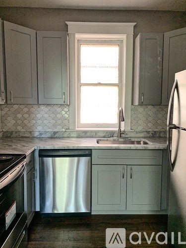 A kitchen with a window above the sink.