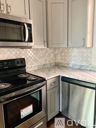 A kitchen with a stove top oven and microwave.