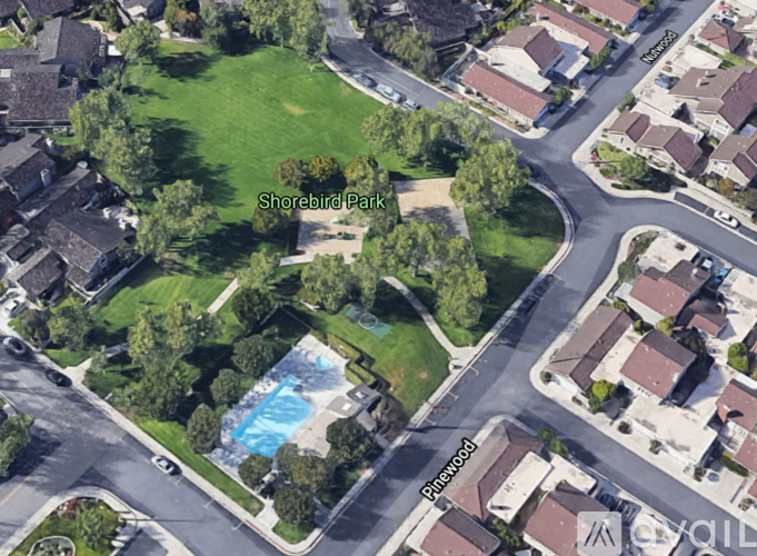 An aerial view of Shorebird Park with a pool and houses.