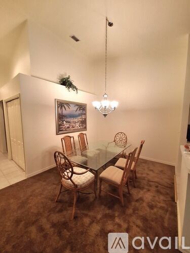 A dining room with a glass table and chairs.