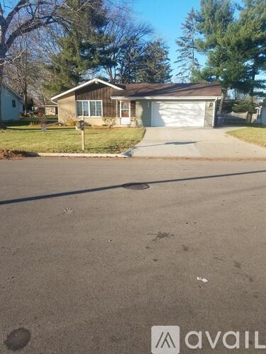 A house with a driveway in front of it.