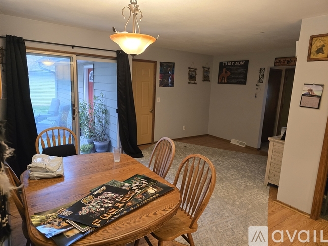A dining room with a wooden table and chairs.
