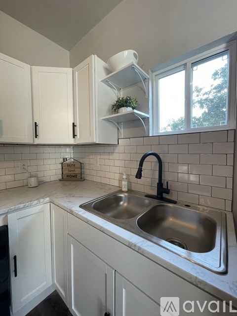 A kitchen with a sink and a window.