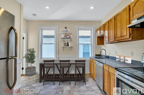 A kitchen with wooden cabinets and a black countertop.