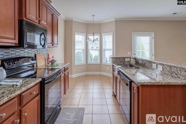 A kitchen with granite countertops and a tile floor.