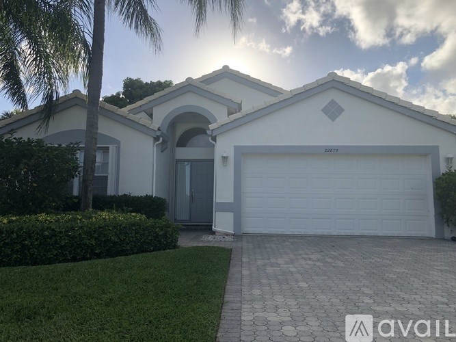 A house with a white garage door and a driveway in front.