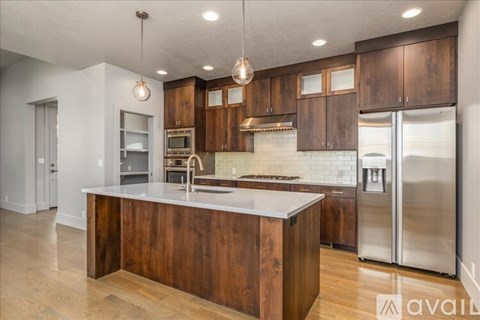 A kitchen with wooden cabinets and a white countertop.